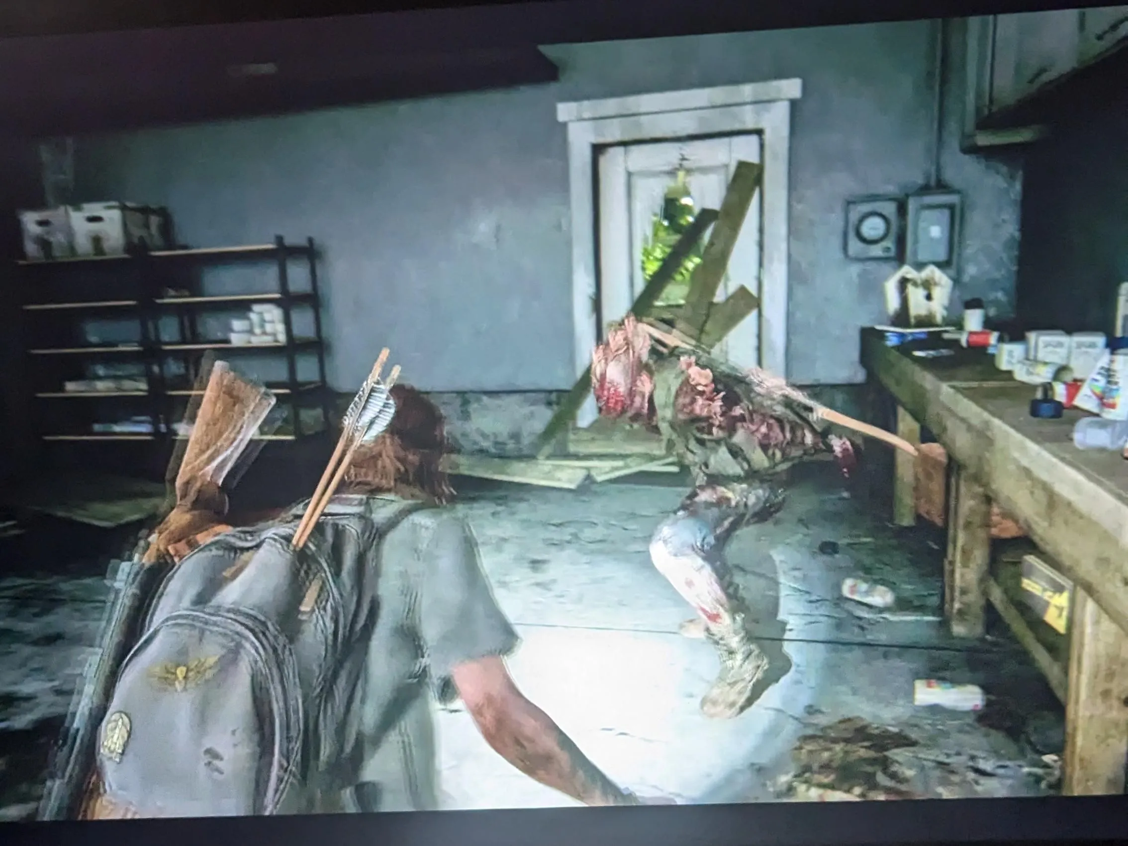 Environmental storytelling in The Last of Us Part II showing abandoned interior with intentional clutter decay and personal objects that tell human stories